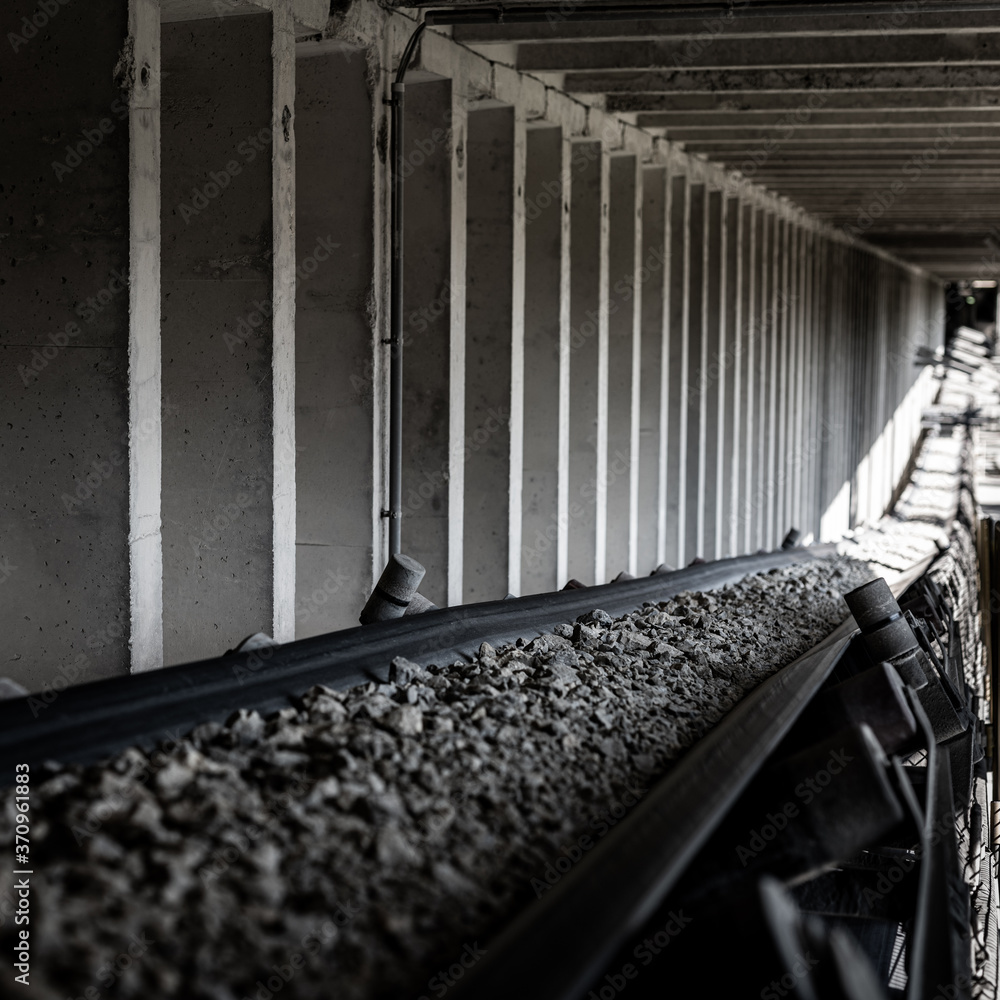 conveyor belt during operation - stones on the production line - industry automation in the mine