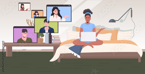 woman chatting with mix race colleagues in web browser windows during video call online conference meeting remote work self isolation concept bedroom interior horizontal vector illustration