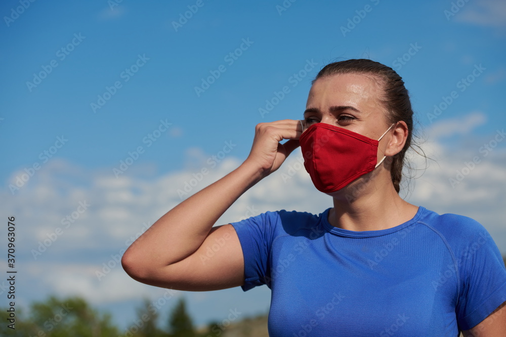 woman with protective mask relaxing after running woman with protective mask relaxing after running