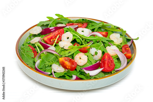 Mediterranean diet menu concept Healthy salad of fresh vegetables - tomatoes, arugula, purple onions, shrimps, soy sauce and sesame seeds in plate on white wooden table Vegan food Flat lay Top view