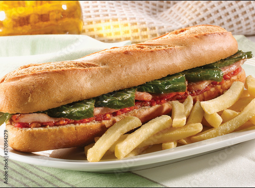 Baguette con lomo y pimientos y patatas fritas. Baguette with loin and peppers and fries. photo