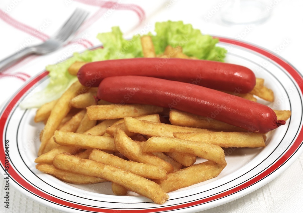 Plate with Sausage and French Fries against White Background Plate with Sausage and French Fries against White Background