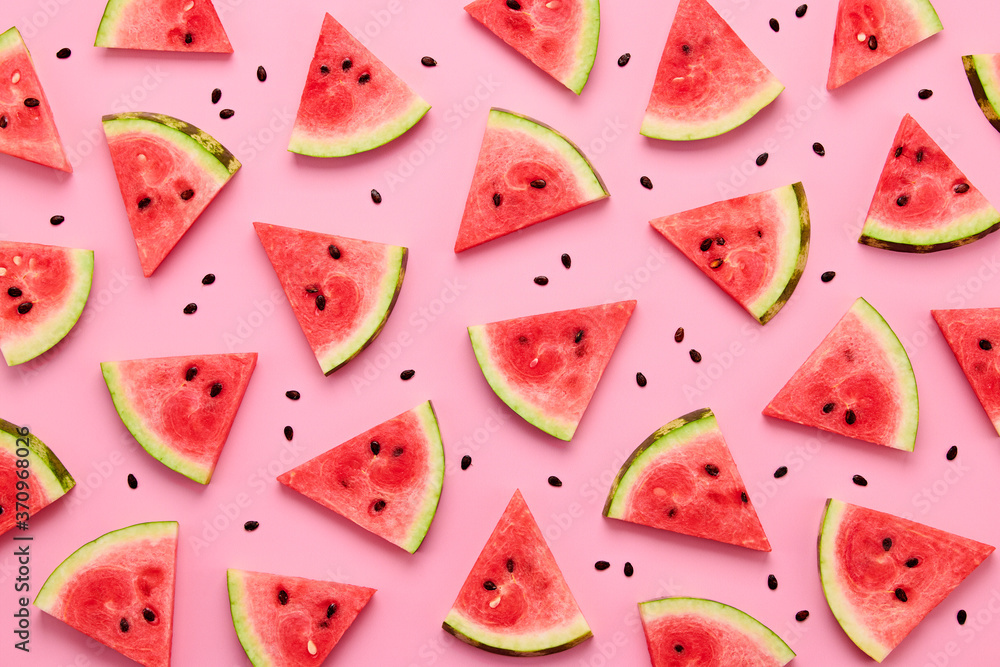 Watermelon colorful pattern on pink background. Fresh red watermelon slices closeup, wallpaper, top view. Creative summer concept, fashionable trendy flat lay Watermelon colorful pattern on pink background. Fresh red watermelon slices closeup, wallpaper, top view. Creative summer concept, fashionable trendy flat lay