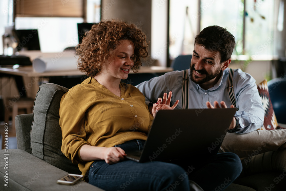 Colleagues in office. Businesswoman and businessman discussing work in office. Two friends in working together... Colleagues in office. Businesswoman and businessman discussing work in office. Two friends in working together...