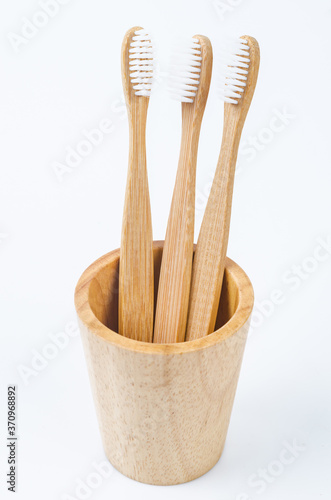 Bamboo toothbrush in wooden glass.