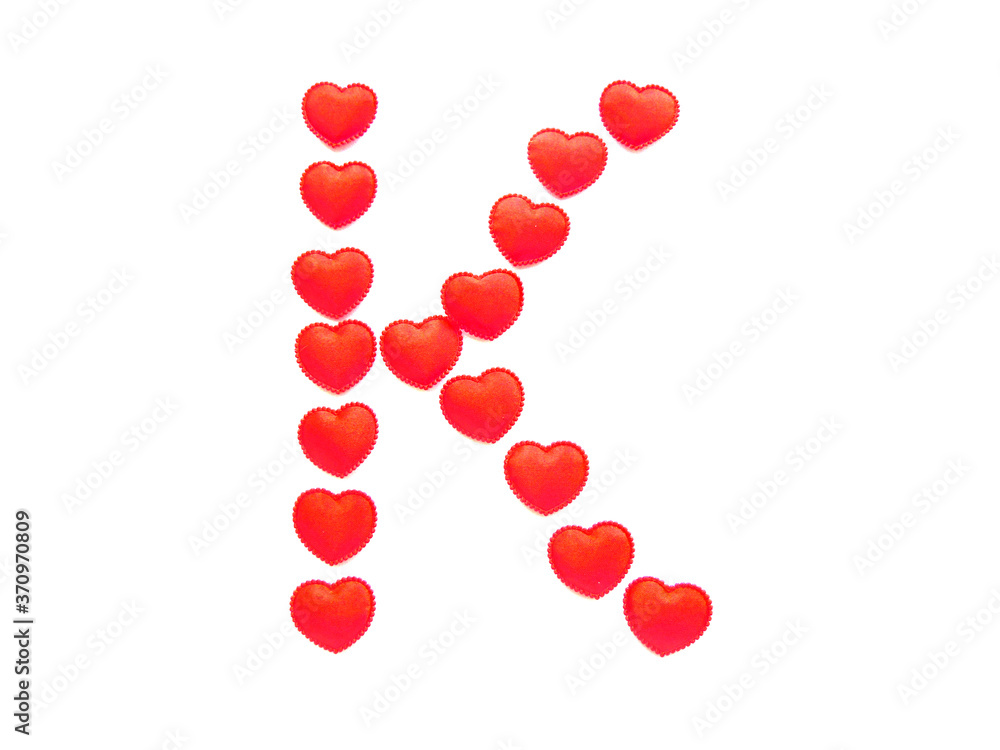 The letter K is made up of small red hearts isolated on a white background. Bright red font. The letter K is made up of small red hearts isolated on a white background. Bright red font.