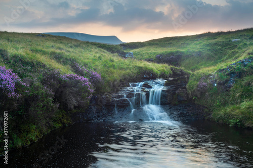 Heavy clouds at sunset over a waterfall on the river Tawe in the Brecon Beacons, South Wales, UK
 photo