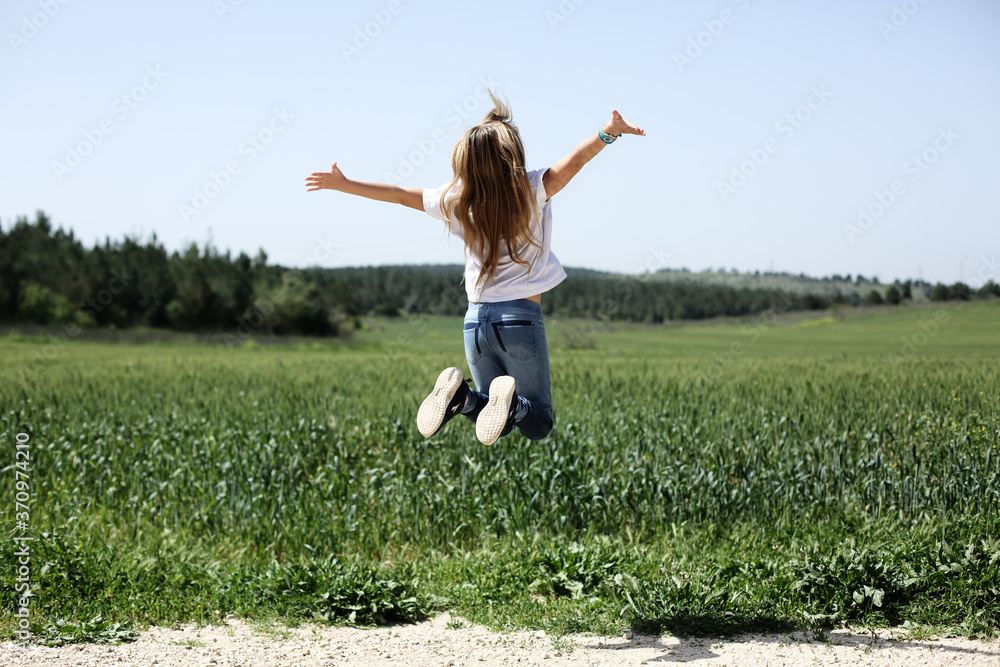 9 year old girl walking in the flowers field 9 year old girl walking in the flowers field