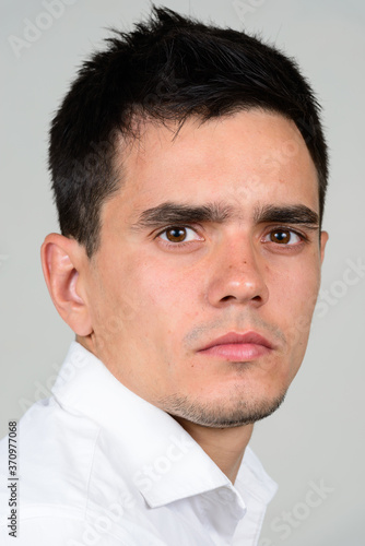 Portrait of handsome businessman against white background