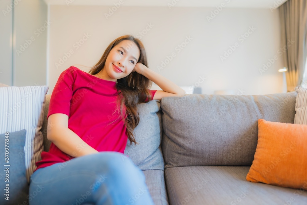 Portrait beautiful young asian woman relax smile on sofa in living area Portrait beautiful young asian woman relax smile on sofa in living area