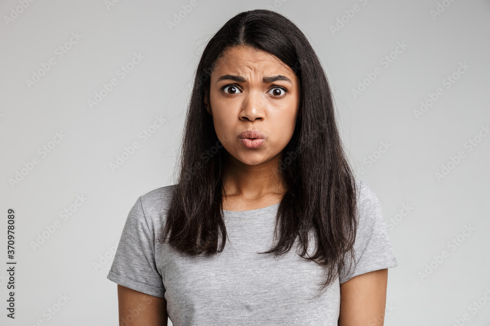 Confused young african lady dressed in casual clothes Confused young african lady dressed in casual clothes