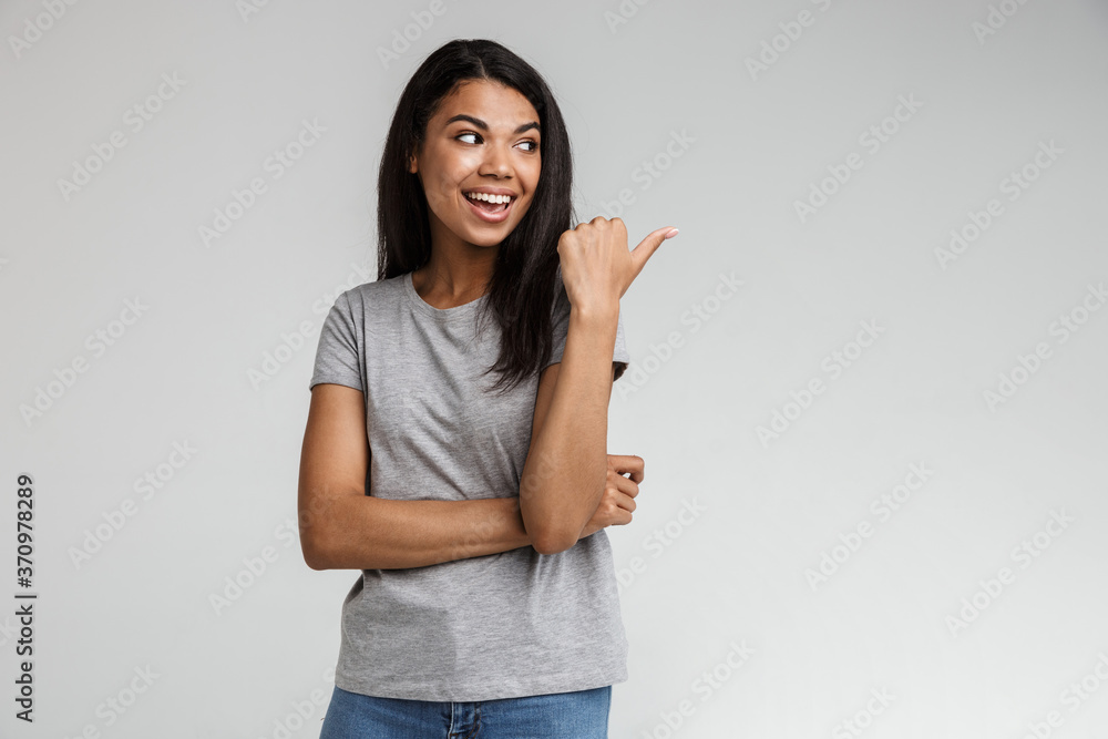 Smiling young african woman pointing at copy space Smiling young african woman pointing at copy space