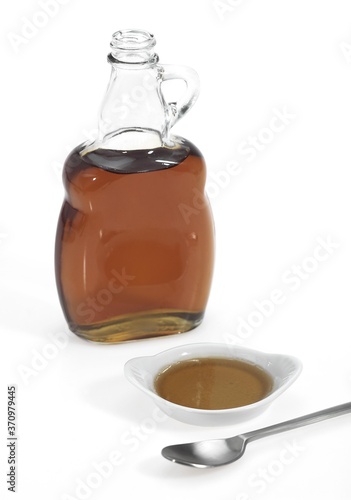 Bottle of Maple Syrup against White Background