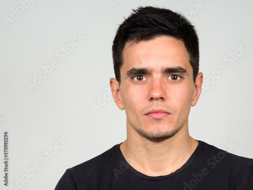 Portrait of handsome man against white background
