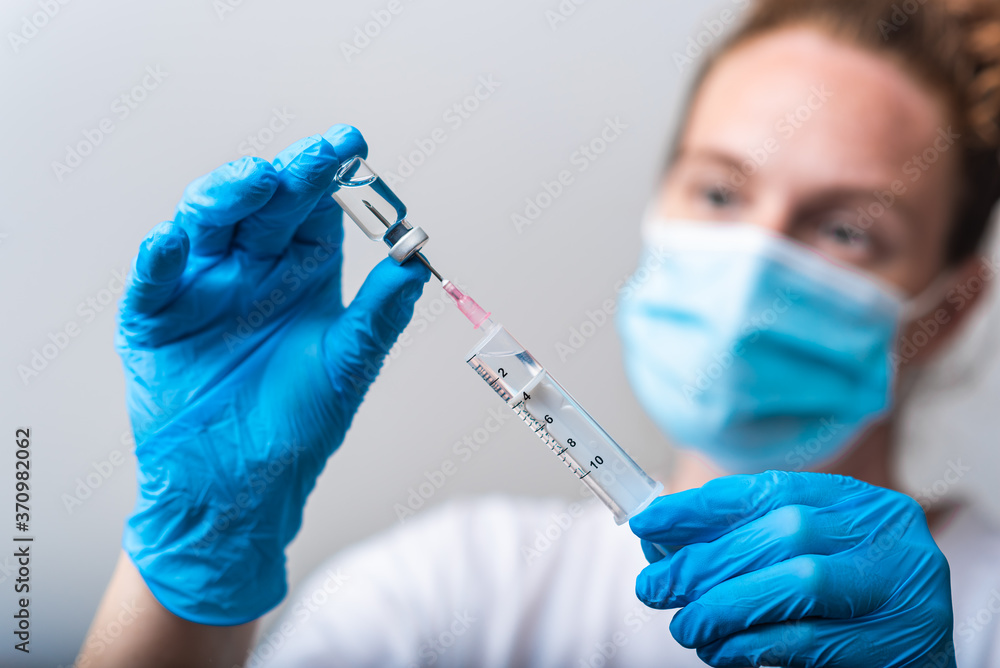 Portrait of medical worker preparing injection with Corona virus vaccine Portrait of medical worker preparing injection with Corona virus vaccine