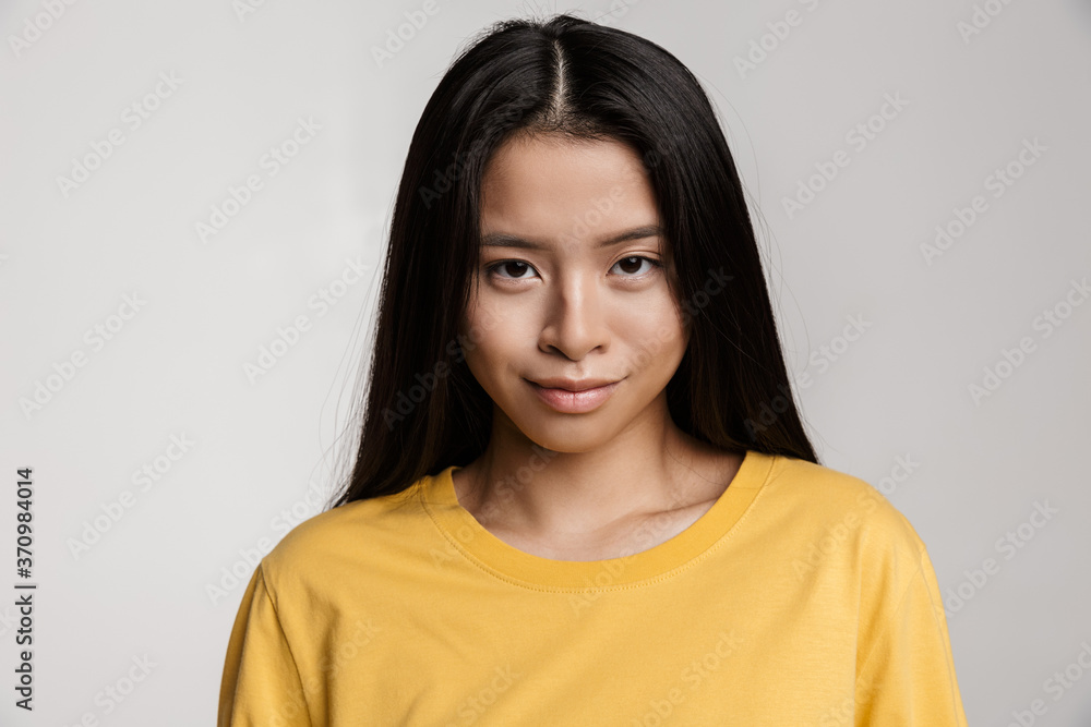 Beautiful young asian woman isolated on gray Beautiful young asian woman isolated on gray