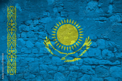 national flag of the state of Kazakhstan on an old stone wall with cracks, the concept of tourism, emigration, economy, politics, global world trade