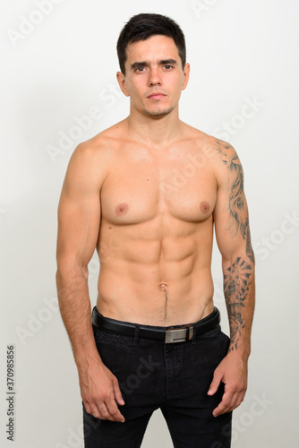 Portrait of handsome muscular shirtless man against white background