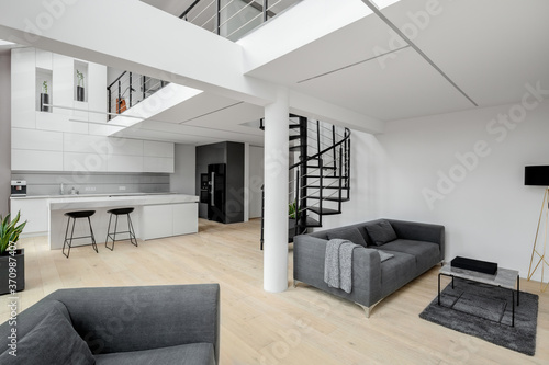 White apartment with mezzanine and stairs photo