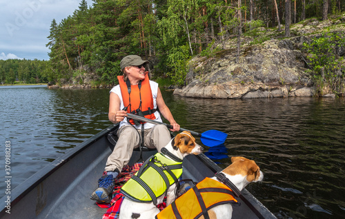 Woman canoeing at the lake with dog in Finland 