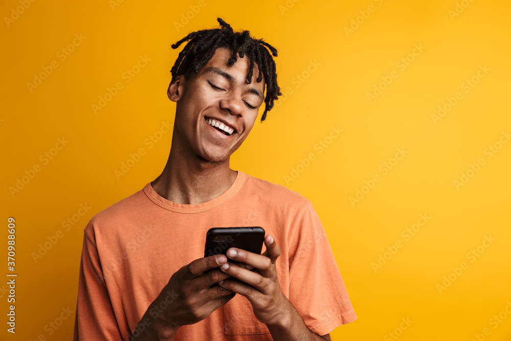 Young happy african man with cellphone isolated Young happy african man with cellphone isolated