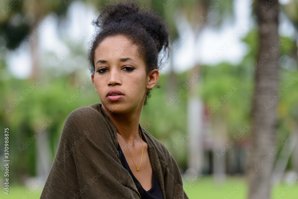 Portrait of young beautiful African woman at the park outdoors Portrait of young beautiful African woman at the park outdoors