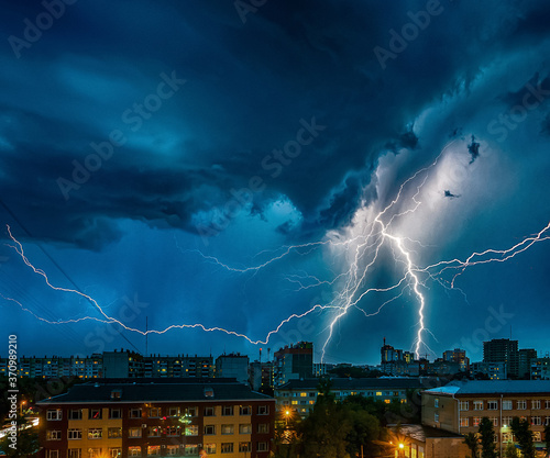 a strong thunderstorm with ligtnings over the city