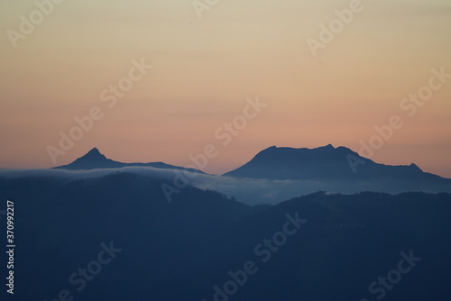 Fototapeta Naklejka Na Ścianę i Meble -  beautiful sunset on the mountains with orange sky and view to the alps
