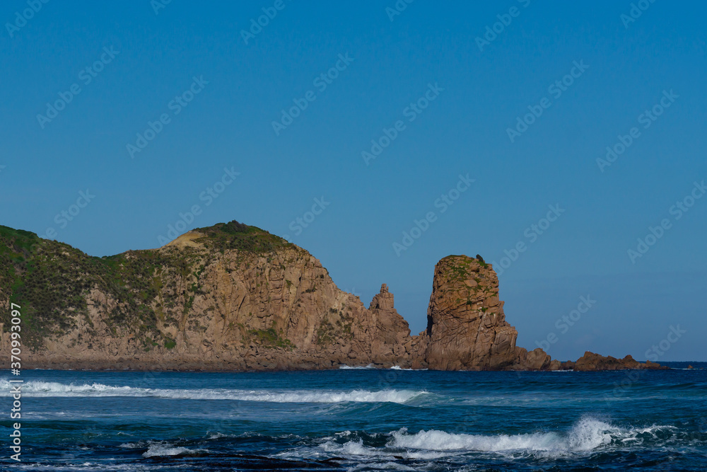 Cliff and sea with blue sky in background