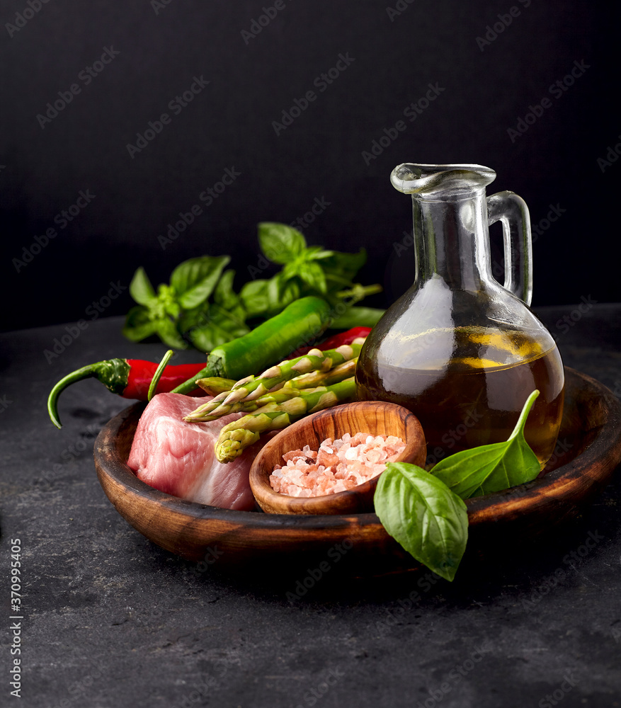 Meat on the black stone with pepper, basil. pepper, asparagus and olive oil. Meat steak with spices. Meat on the black stone with pepper, basil. pepper, asparagus and olive oil. Meat steak with spices.