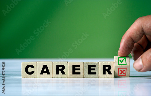 hand turns the wooden cube and changes the word CAREER