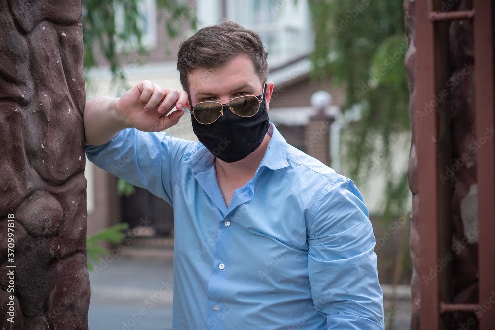 Social distance. Stop virus ! Young Man in Textile black cotton mask Social distance. Stop virus ! Young Man in Textile black cotton mask