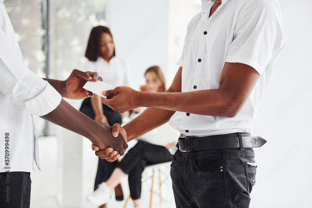 Obraz premium Doing handshake. Successful deal. Group of african american business people working in office together