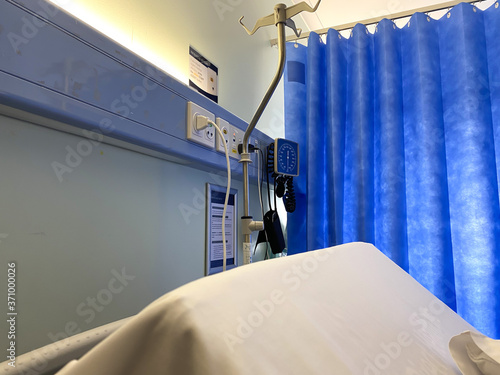 Hospital room with intravenous stand and blood pressure monitor