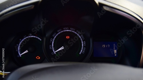 instrument panel in the car, where the radiator of the handbrake and engine are lit. close-up dark background.