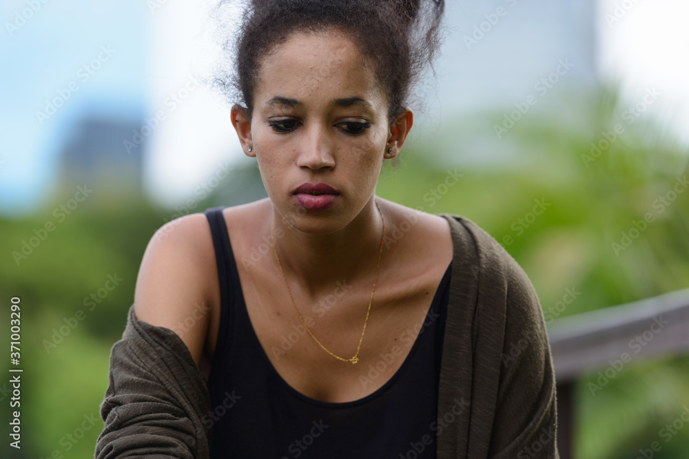 Portrait of young beautiful African woman at the park outdoors Portrait of young beautiful African woman at the park outdoors