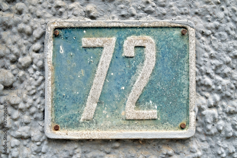 Number 72, seventy-four, on a pale blue background. Number 72, seventy-four, on a pale blue background.