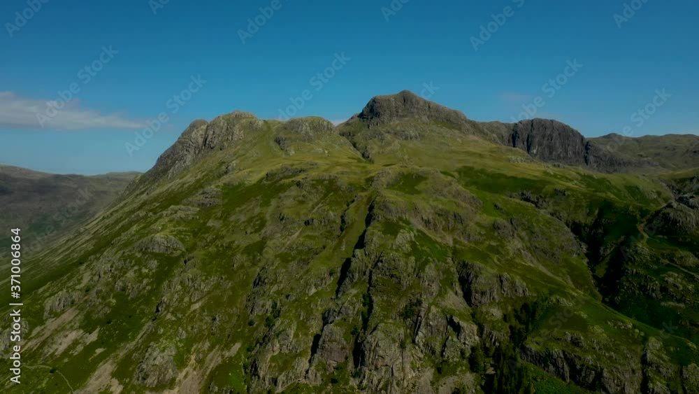 4K: Drone Aerial Clip of the Langdales, Mountains in the English Lake District, Cumbria, UK. Circular shot in Summer with Blue Sky. Stock Video Clip Footage 4K: Drone Aerial Clip of the Langdales, Mountains in the English Lake District, Cumbria, UK. Circular shot in Summer with Blue Sky. Stock Video Clip Footage