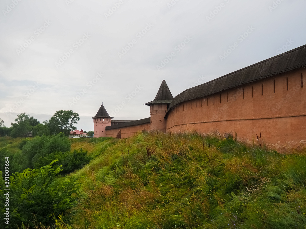 photo of the gates and towers of the Suzdal Kremlin in cloudy times
