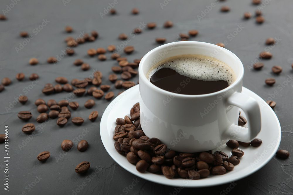 Fototapeta premium coffee beans and coffee cup on colored background with place for text 