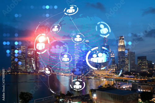 Glowing Social media icons on night panoramic city view of Singapore  Asia. The concept of networking and establishing new connections between people and businesses. Double exposure.