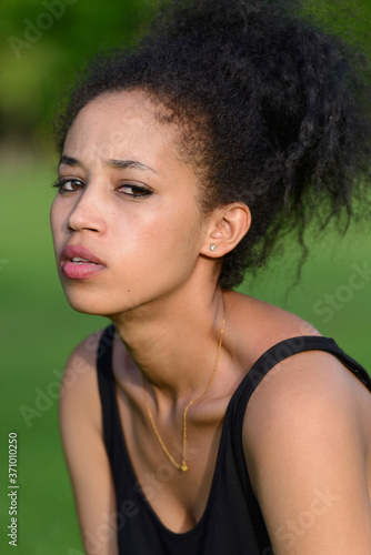 Portrait of young beautiful African woman at the park outdoors