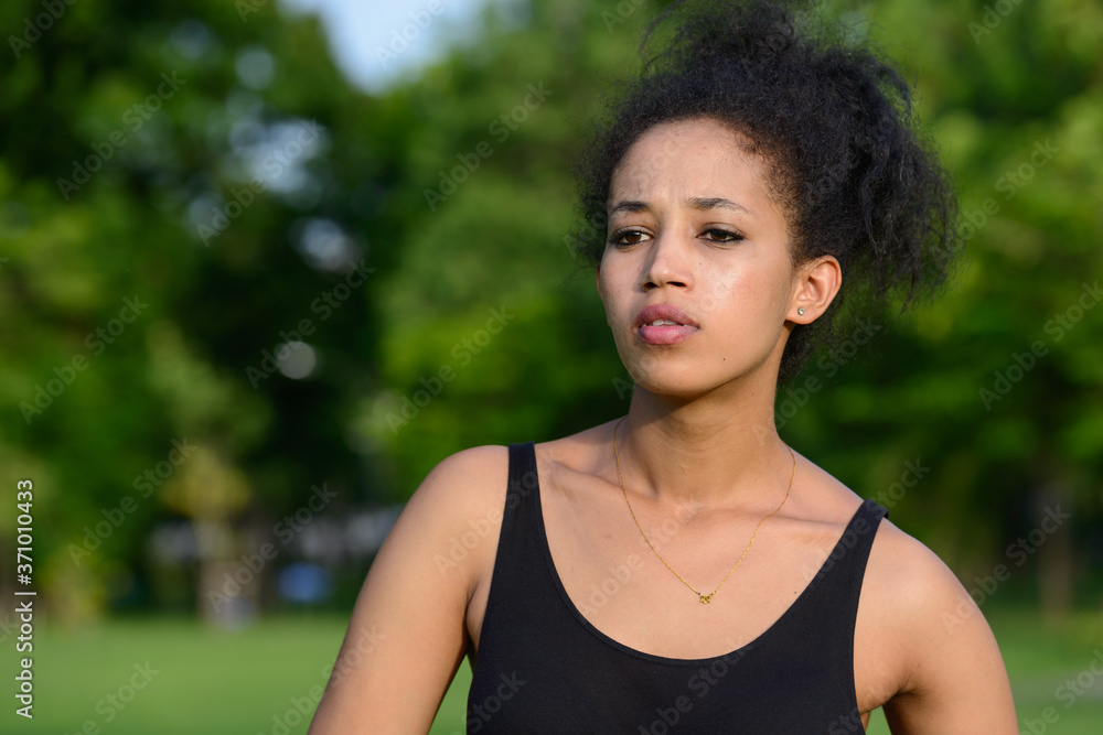 Portrait of young beautiful African woman at the park outdoors Portrait of young beautiful African woman at the park outdoors