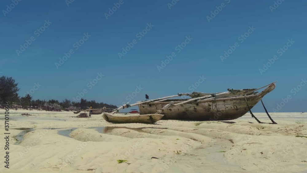 Traditional wooden fishing boats in the turquoise ocean waters. Zanzibar Paje beach. Traditional wooden fishing boats in the turquoise ocean waters. Zanzibar Paje beach.