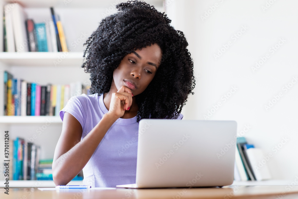 Thinking african american woman at computer Thinking african american woman at computer