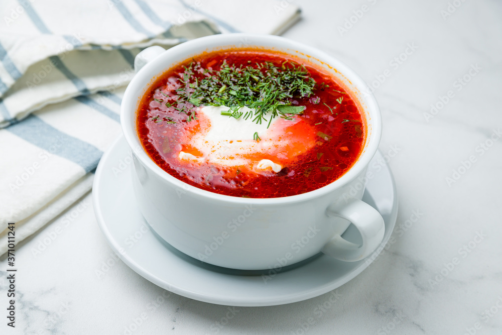 Borscht with sour cream on marble table Borscht with sour cream on marble table