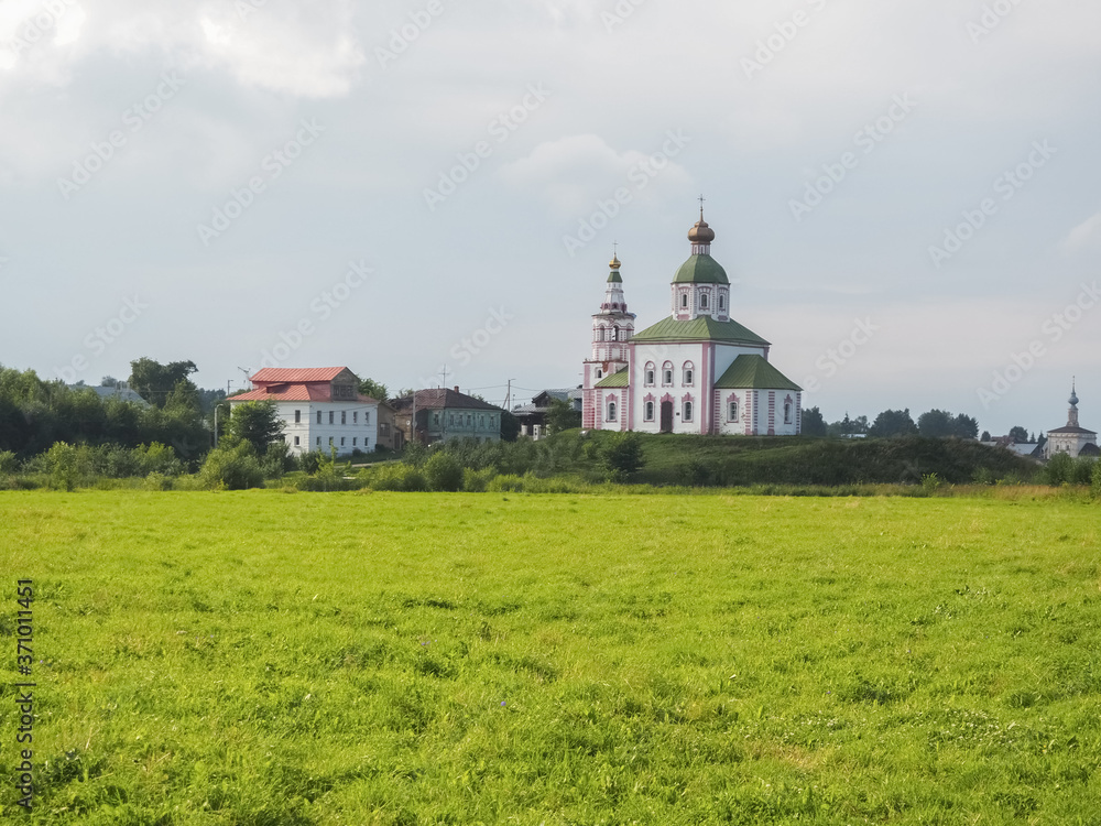photo of a wide Russian field with white stone Orthodox churches