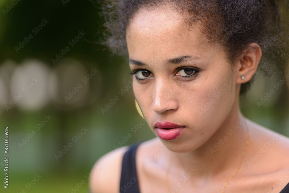Portrait of young beautiful African woman at the park outdoors Portrait of young beautiful African woman at the park outdoors