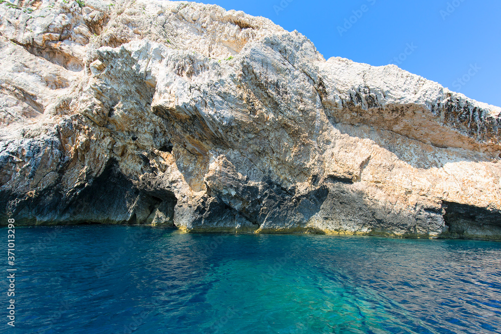 Blue Cave carved in the limestone by the Adriatic Sea, view from the water, Bisevo Island, Croatia