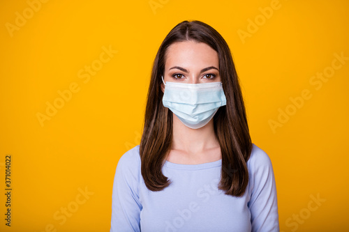 Close-up portrait of her she attractive pretty brown-haired girl wearing safety mask stop flue gripe viral pneumonia symptom syndrome isolated bright vivid shine vibrant yellow color background © deagreez